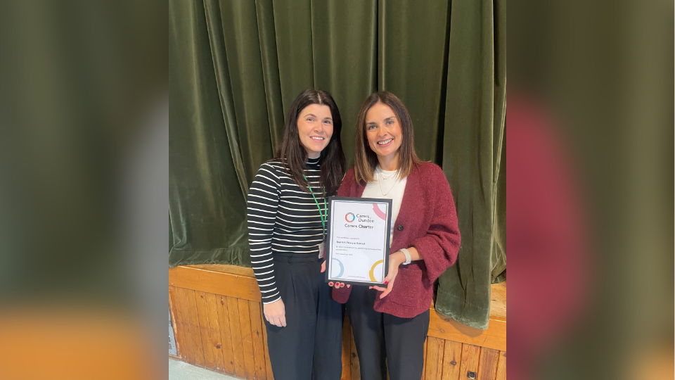 Julie Caird, Dundee Carers Centre Support Worker and Anne McGregor, Head Teacher for Barnhill Primary schoo,l pose for a photo while holding the Carers of Dundee Carers Centre certificate.