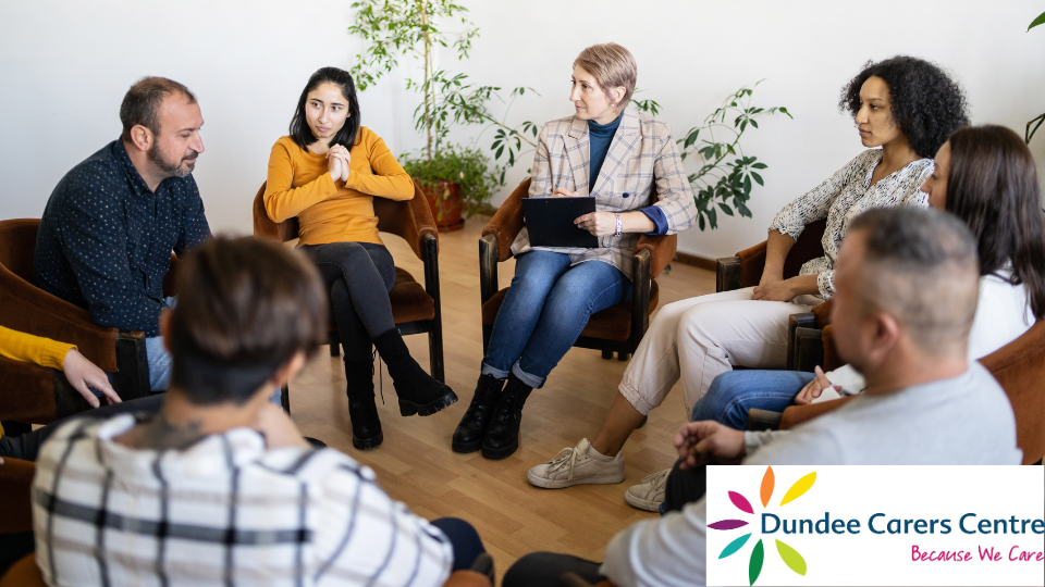 Group of people sitting in a circle. Dundee Carers Centre logo is on bottom right.