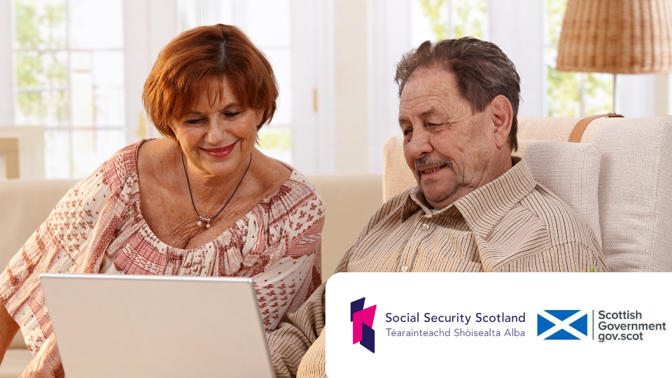 Older woman and man sitting together on a couch looking at a laptop. Bottom right: Scottish government logo and social security scotland logo