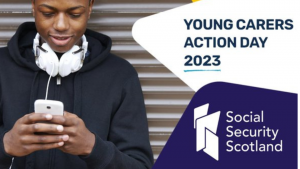 Young man looking down at a mobile device. "Young Carers Action Day 2023" and the Social Security Scotland logo is next to the image. 